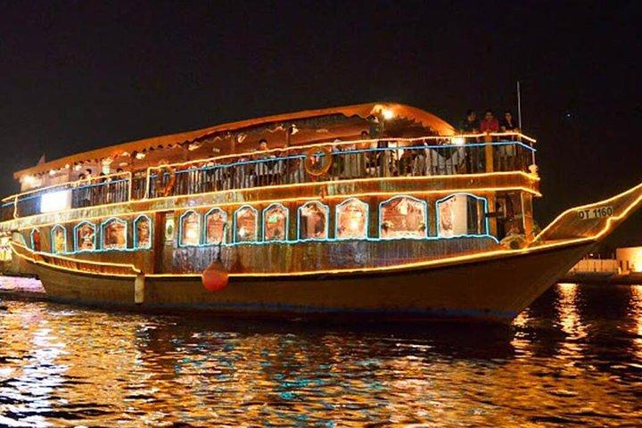 Sail along the shimmering waters of Dubai enjoying a delightful dinner on a beautifully illuminated dhow surrounded by stunning views and the gentle sounds of the evening breeze.